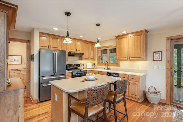 268 Trappers Run Dr, Burnsville, NC 28714 - kitchen with black appliances, under cabinet range hood, light wood finished floors, recessed lighting, and a kitchen island