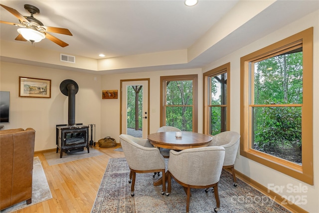 268 Trappers Run Dr, Burnsville, NC 28714 - dining room with a wood stove, light wood-style flooring, baseboards, recessed lighting, and a ceiling fan