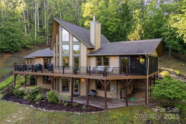 268 Trappers Run Dr, Burnsville, NC 28714 - back of house with a patio area, a wooden deck, roof with shingles, and a chimney