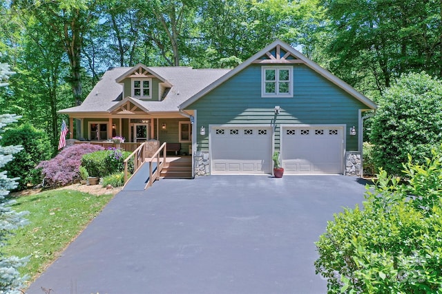 399 Stepping Stone Ln, Waynesville, NC 28786 - view of front of house featuring a porch, driveway, stone siding, and a garage
