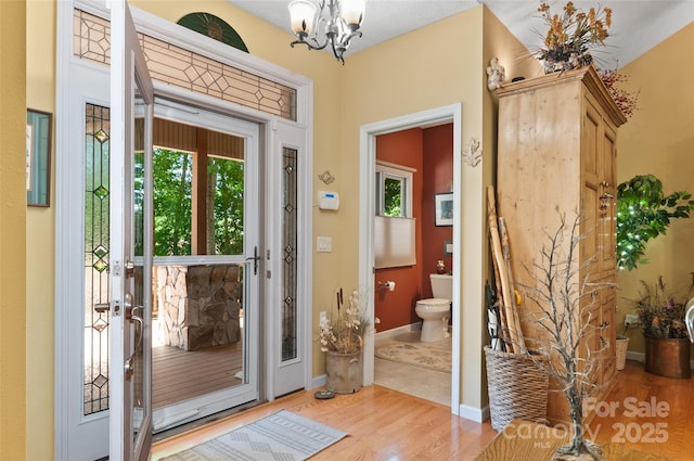 399 Stepping Stone Ln, Waynesville, NC 28786 - entryway featuring wood finished floors and a chandelier