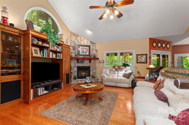 399 Stepping Stone Ln, Waynesville, NC 28786 - living room featuring plenty of natural light, a ceiling fan, light wood-style floors, lofted ceiling, and a fireplace