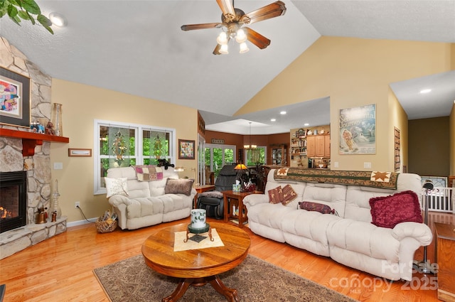 399 Stepping Stone Ln, Waynesville, NC 28786 - living room with a ceiling fan, a fireplace, wood finished floors, and high vaulted ceiling