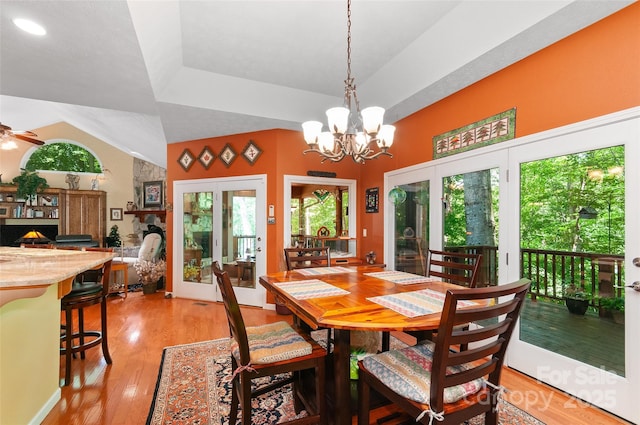 399 Stepping Stone Ln, Waynesville, NC 28786 - dining room featuring french doors, light wood-style flooring, a chandelier, and a ceiling fan