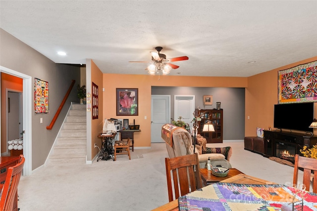 399 Stepping Stone Ln, Waynesville, NC 28786 - carpeted dining area featuring a ceiling fan, stairway, and a glass covered fireplace