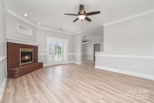 6201 New Hope Church Rd, Marshville, NC 28103 - unfurnished living room with a brick fireplace, light wood-type flooring, crown molding, a ceiling fan, and baseboards