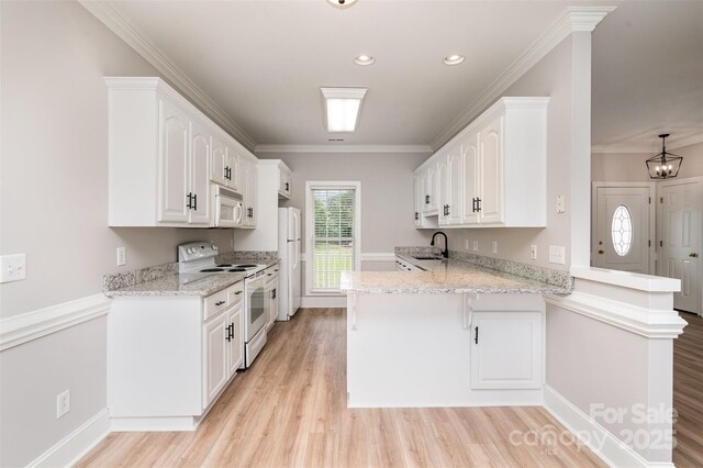 6201 New Hope Church Rd, Marshville, NC 28103 - kitchen with white appliances, a peninsula, light wood-type flooring, white cabinetry, and a breakfast bar