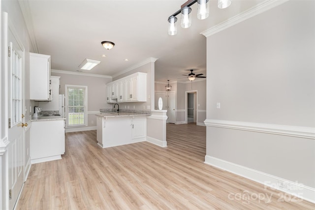 6201 New Hope Church Rd, Marshville, NC 28103 - kitchen featuring white cabinets, ornamental molding, light wood-style flooring, a ceiling fan, and a peninsula