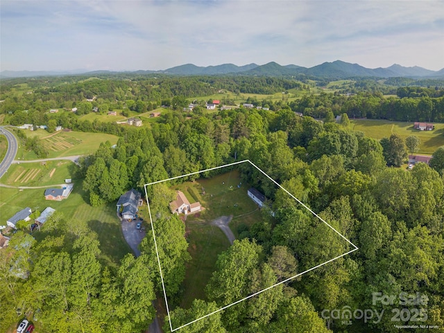 21 Betty Dr, Leicester, NC 28748 - aerial view of property and surrounding area featuring property boundaries highlighted, a heavily wooded area, and mountains