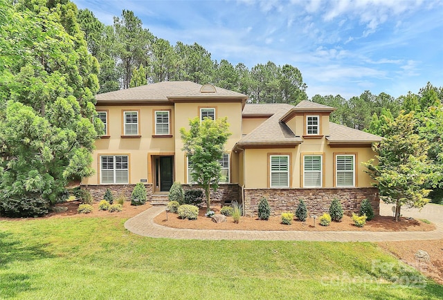 11052 Preservation Park Dr, Charlotte, NC 28214 - view of front facade with stucco siding, a front yard, and stone siding
