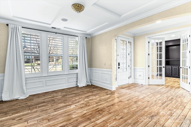 11052 Preservation Park Dr, Charlotte, NC 28214 - spare room with wood finished floors, crown molding, wainscoting, a decorative wall, and arched walkways