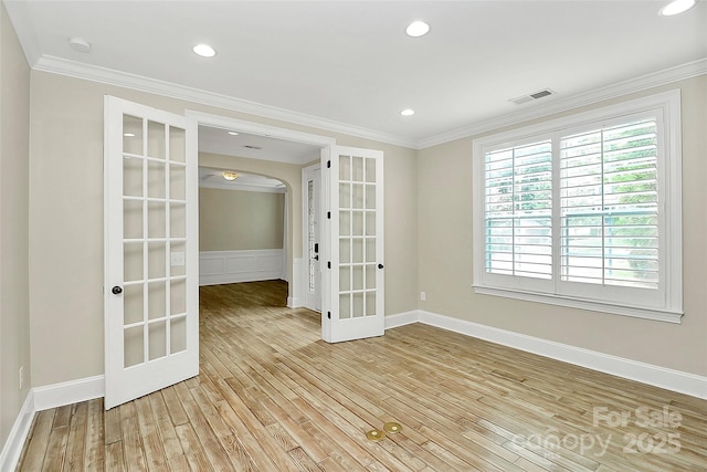 11052 Preservation Park Dr, Charlotte, NC 28214 - spare room featuring french doors, healthy amount of natural light, light wood-style flooring, ornamental molding, and a smoke detector