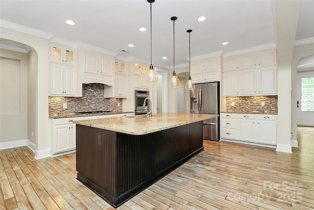 11052 Preservation Park Dr, Charlotte, NC 28214 - kitchen with arched walkways, appliances with stainless steel finishes, light wood finished floors, backsplash, and recessed lighting