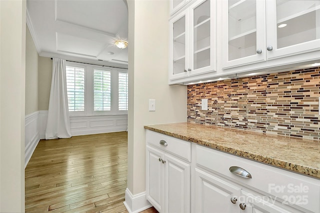 11052 Preservation Park Dr, Charlotte, NC 28214 - bar area with light wood-style flooring, decorative backsplash, wainscoting, ornamental molding, and a decorative wall