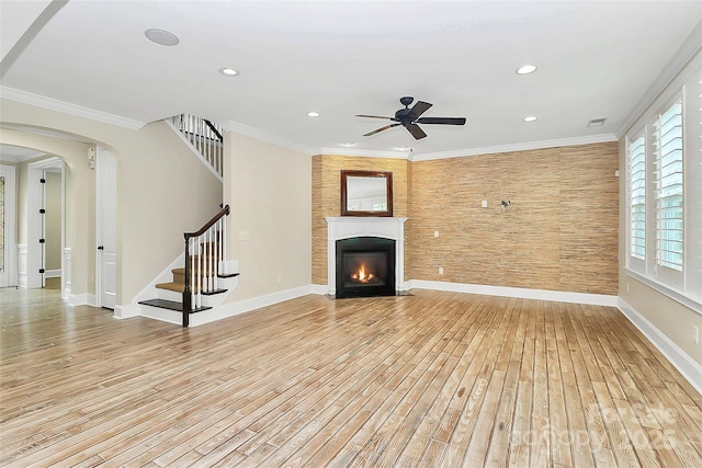 11052 Preservation Park Dr, Charlotte, NC 28214 - unfurnished living room featuring light wood-style flooring, a ceiling fan, stairs, baseboards, and a fireplace with flush hearth