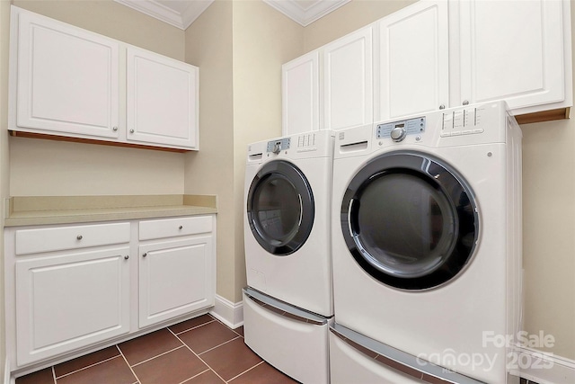 11052 Preservation Park Dr, Charlotte, NC 28214 - washroom with washing machine and clothes dryer, cabinet space, ornamental molding, dark tile patterned flooring, and baseboards