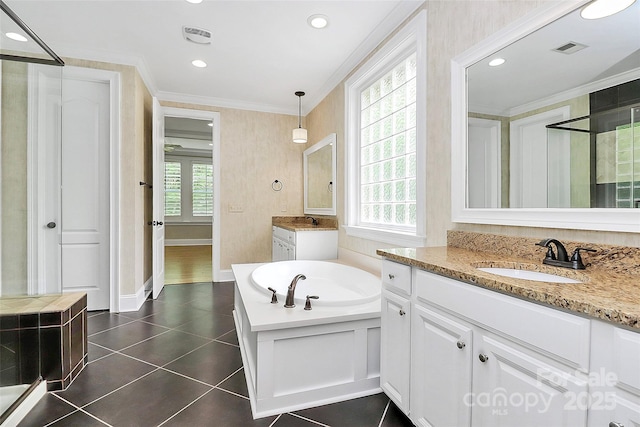11052 Preservation Park Dr, Charlotte, NC 28214 - full bathroom with ornamental molding, plenty of natural light, a garden tub, two vanities, and tile patterned flooring