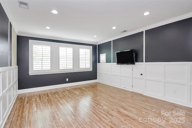 11052 Preservation Park Dr, Charlotte, NC 28214 - unfurnished living room featuring crown molding, a decorative wall, light wood-style floors, recessed lighting, and baseboards