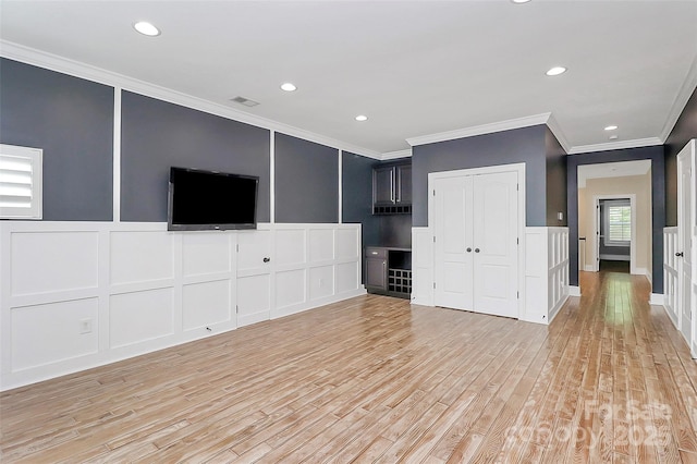 11052 Preservation Park Dr, Charlotte, NC 28214 - unfurnished living room featuring a decorative wall, ornamental molding, light wood-style flooring, and recessed lighting