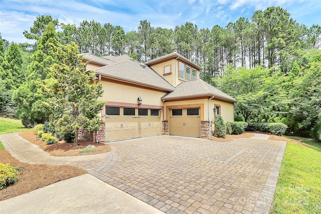 11052 Preservation Park Dr, Charlotte, NC 28214 - view of property exterior featuring stucco siding, stone siding, an attached garage, driveway, and a shingled roof