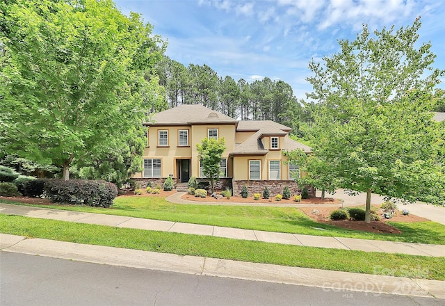11052 Preservation Park Dr, Charlotte, NC 28214 - view of front of house with stucco siding, stone siding, and a front yard