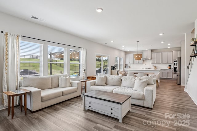 15023 Longmoore Dr, Charlotte, NC 28278 - living area featuring wood finished floors, recessed lighting, and baseboards