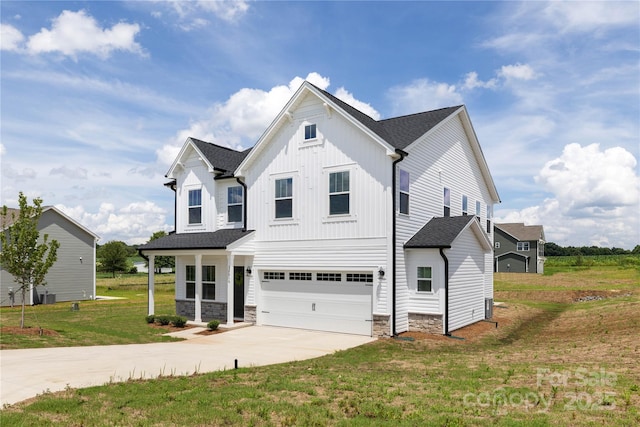 32616 Millingport Rd Unit 7144, New London, NC 28127 - view of front of house featuring driveway, a garage, a front yard, stone siding, and board and batten siding