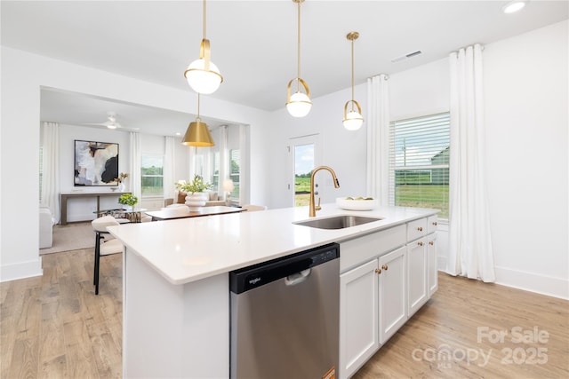 32616 Millingport Rd Unit 7144, New London, NC 28127 - kitchen with stainless steel dishwasher, light wood finished floors, white cabinetry, an island with sink, and light countertops