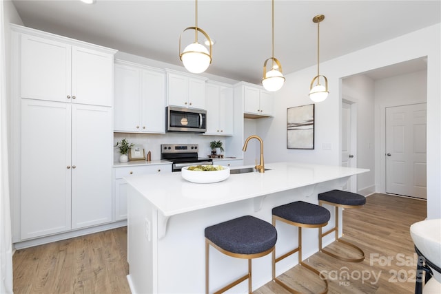 32616 Millingport Rd Unit 7144, New London, NC 28127 - kitchen featuring stainless steel appliances, light wood-style flooring, white cabinetry, and light countertops