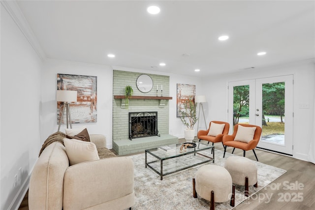 9826 Meringue Pl Unit 15, Charlotte, NC 28270 - living area featuring crown molding, a brick fireplace, wood finished floors, recessed lighting, and french doors