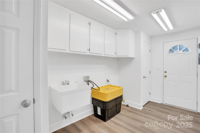 9826 Meringue Pl Unit 15, Charlotte, NC 28270 - laundry area with cabinet space, hookup for a washing machine, light wood finished floors, and baseboards