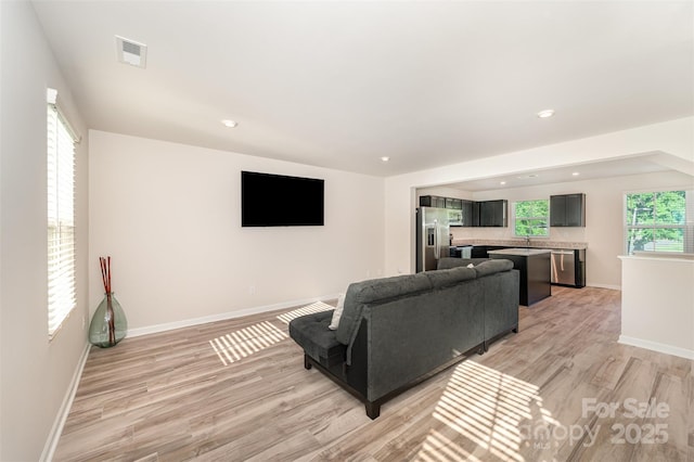 2037 Langer St, Charlotte, NC 28214 - living area featuring light wood-style floors, baseboards, and recessed lighting