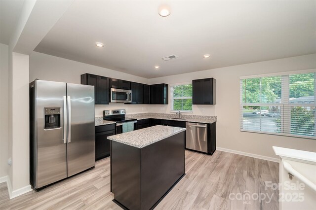 2037 Langer St, Charlotte, NC 28214 - kitchen featuring appliances with stainless steel finishes, a sink, light wood-type flooring, a center island, and recessed lighting