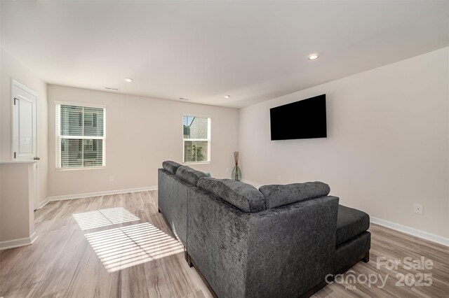 2037 Langer St, Charlotte, NC 28214 - living room featuring light wood-style flooring, baseboards, and recessed lighting