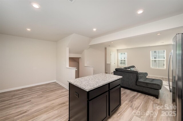 2037 Langer St, Charlotte, NC 28214 - kitchen with freestanding refrigerator, open floor plan, light wood-type flooring, baseboards, and recessed lighting