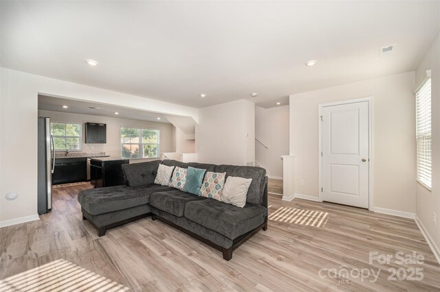 2037 Langer St, Charlotte, NC 28214 - living area featuring light wood-type flooring, baseboards, and recessed lighting