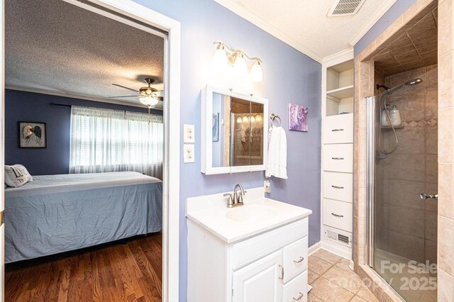 bathroom with ensuite bath, a textured ceiling, a stall shower, crown molding, and vanity