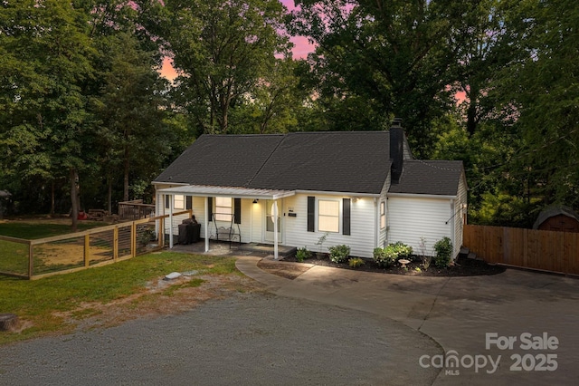 800 Woodlawn St, Belmont, NC 28012 - view of front of property with concrete driveway, covered porch, a chimney, and view of scattered trees
