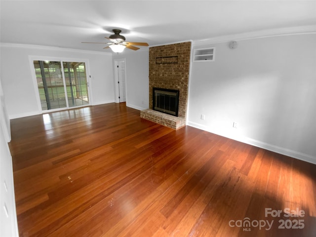 10518 Fairway Ridge Rd, Charlotte, NC 28277 - unfurnished living room with ceiling fan, wood finished floors, crown molding, a brick fireplace, and baseboards