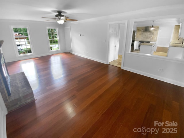 10518 Fairway Ridge Rd, Charlotte, NC 28277 - unfurnished living room with a ceiling fan, wood finished floors, baseboards, a sink, and crown molding