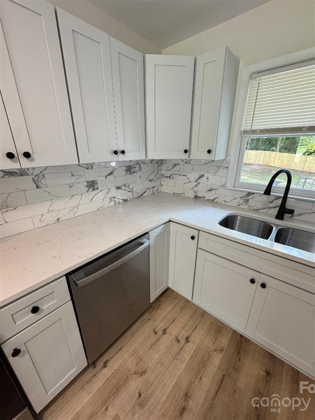 3700 Denson Pl, Charlotte, NC 28215 - kitchen featuring stainless steel dishwasher, a sink, light wood-style flooring, and light countertops