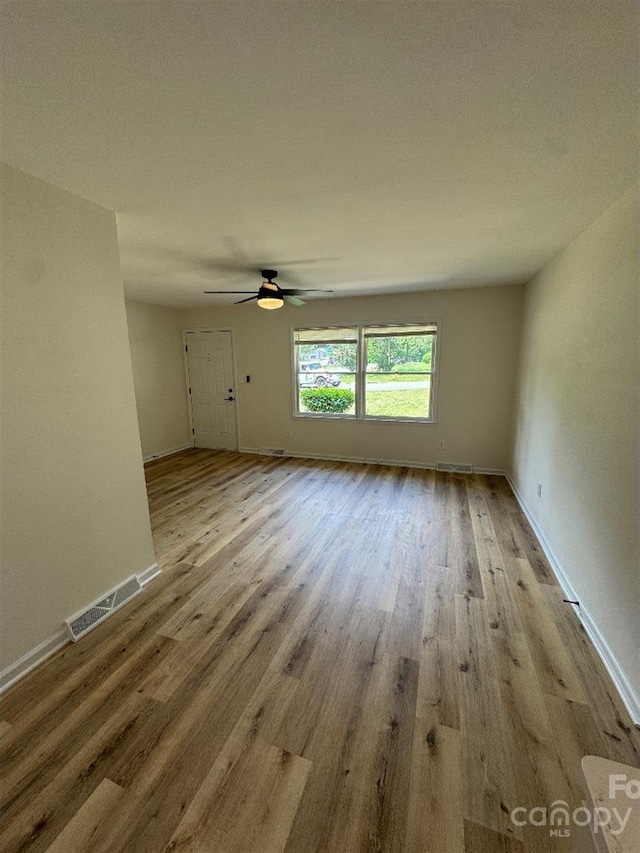 3700 Denson Pl, Charlotte, NC 28215 - unfurnished living room featuring wood finished floors, baseboards, and a ceiling fan