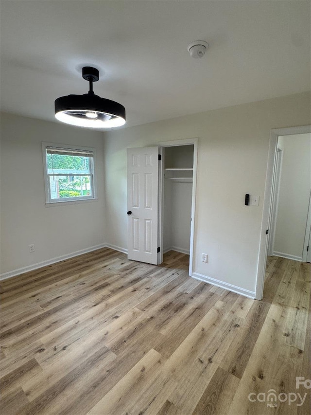 3700 Denson Pl, Charlotte, NC 28215 - unfurnished bedroom with light wood-style floors, baseboards, and a closet