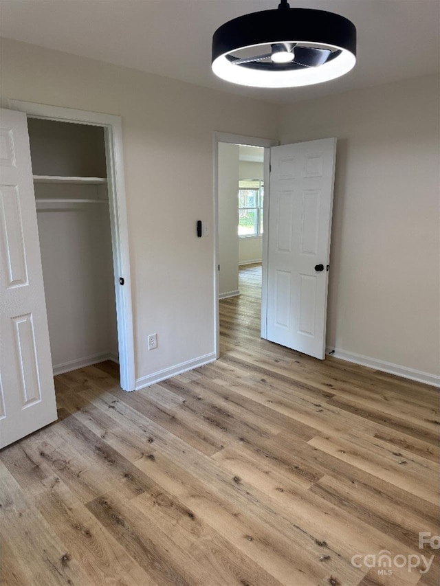 3700 Denson Pl, Charlotte, NC 28215 - unfurnished bedroom with wood finished floors, baseboards, and a closet