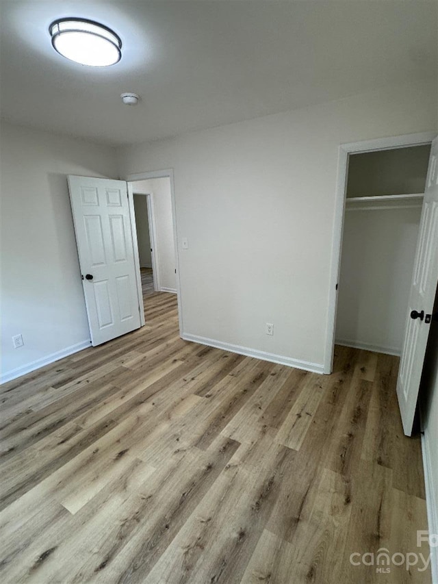 3700 Denson Pl, Charlotte, NC 28215 - unfurnished bedroom with wood finished floors and baseboards