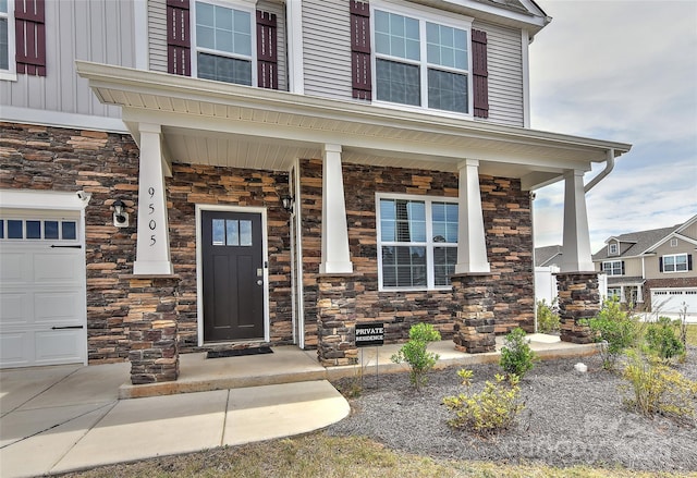 9505 Cotswood Pl, Gastonia, NC 28056 - doorway to property with stone siding, covered porch, a garage, and board and batten siding