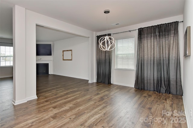 9505 Cotswood Pl, Gastonia, NC 28056 - unfurnished dining area with wood finished floors, a chandelier, and a fireplace