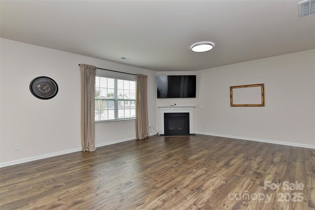 9505 Cotswood Pl, Gastonia, NC 28056 - unfurnished living room with a glass covered fireplace and dark wood-style floors
