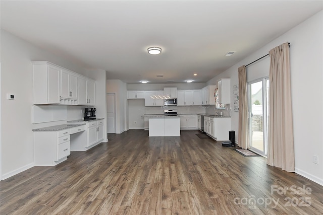 9505 Cotswood Pl, Gastonia, NC 28056 - kitchen with stainless steel appliances, dark wood finished floors, white cabinets, and a center island
