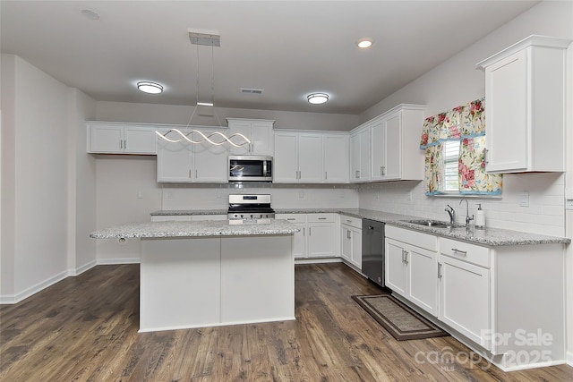 9505 Cotswood Pl, Gastonia, NC 28056 - kitchen featuring appliances with stainless steel finishes, white cabinets, decorative backsplash, and recessed lighting